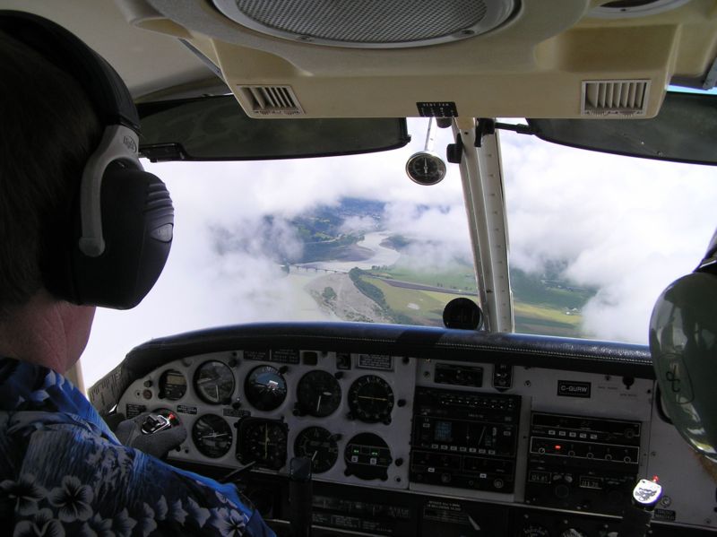 Langley Flying School's Piper Seneca over a broken layer above the coast in Northern California. Pilot: Tom Larkin